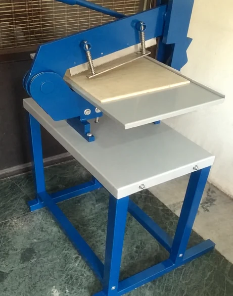 Fabric sample swatch cutter with spring-loaded cutting assembly and support table