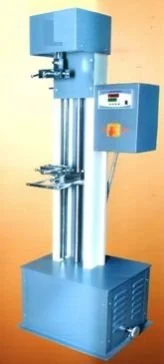 Fabric tensile testing machine with specimen grips and digital control panel