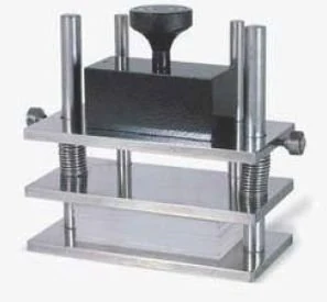 Textile perspiration tester with pressure plates and screw loading frame